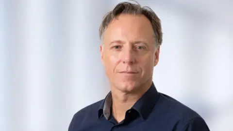 University Medical Center Göttingen Wolfram-Hubertus Zimmermann, professor and researcher from the University Medical Center Göttingen, wears a navy blue shirt and jumper and looks straight at the camera