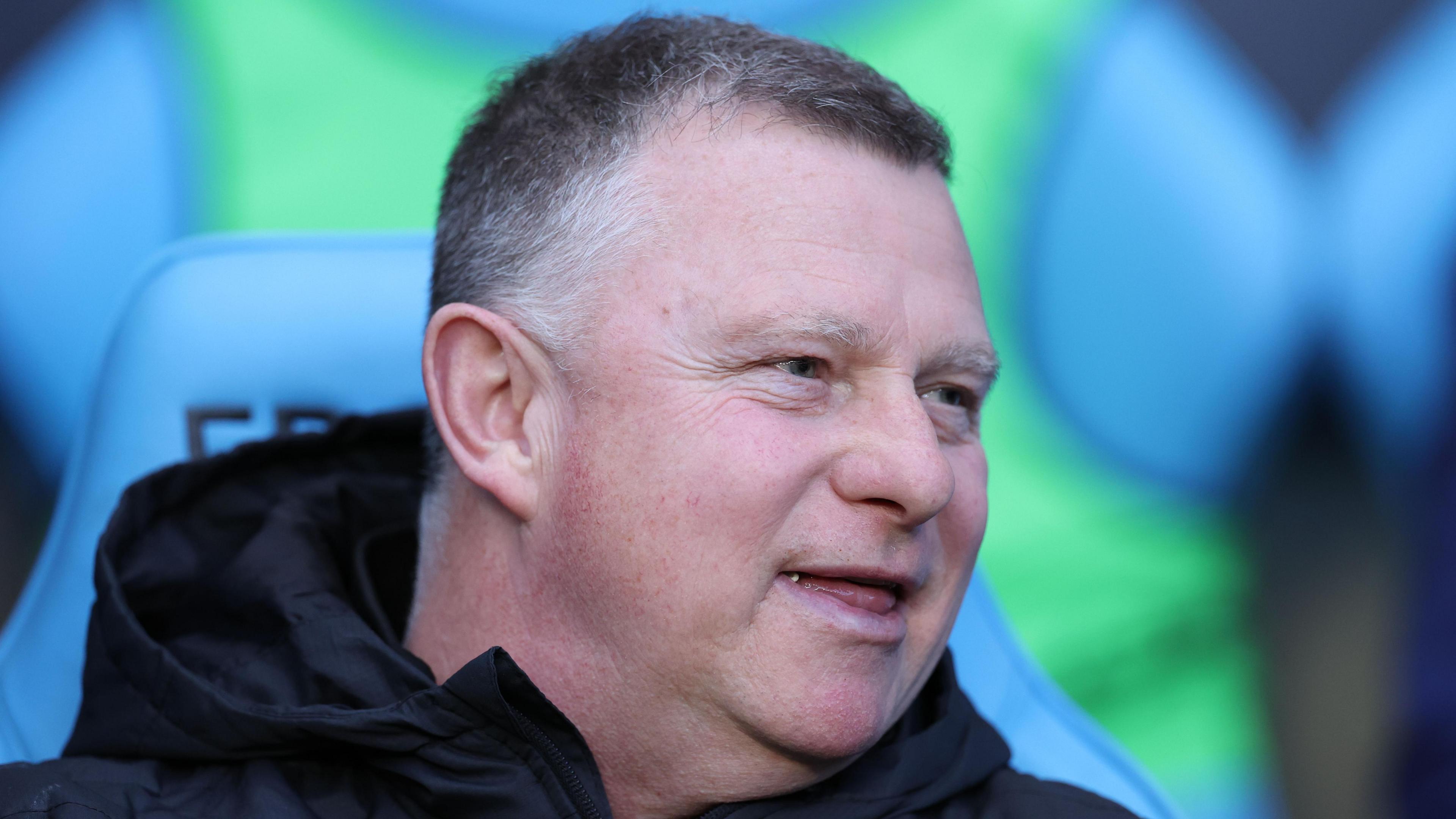 Mark Robins sitting in the dugout during his time as Coventry City boss