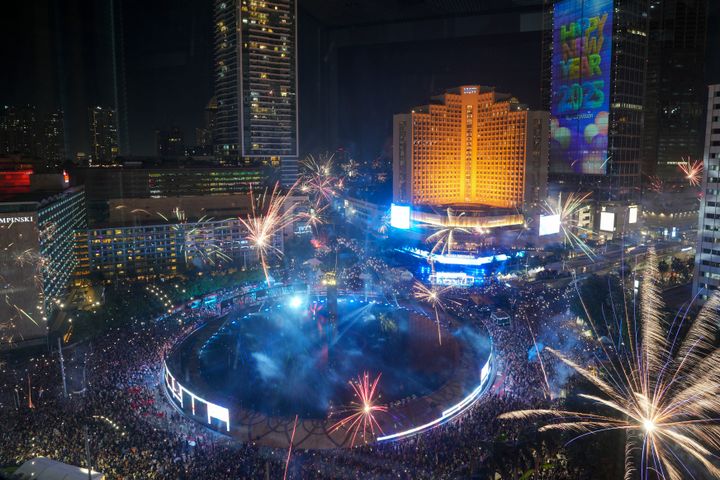 Fireworks explode as thousands of people gather in the main business district on New Year's Eve in Jakarta, Indonesia, Tuesday, Dec. 31, 2024. (AP Photo/Tatan Syuflana)