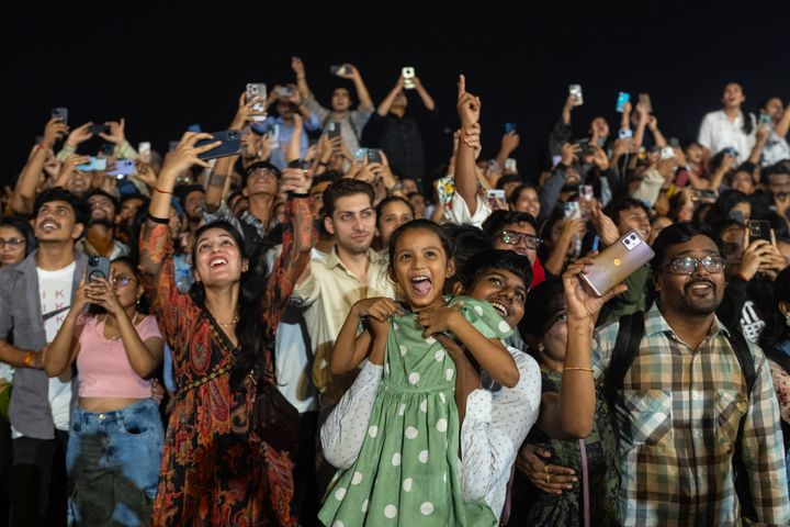 People celebrate the arrival of the New Year at Marine Drive in Mumbai, India, Wednesday, Jan. 1, 2025. (AP Photo/Rafiq Maqbool)