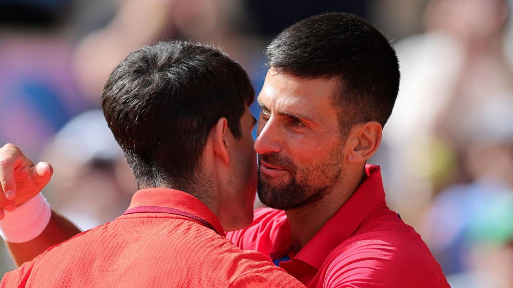 Novak Djokovic hugs Carlos Alcaraz after their Paris 2024 Olympics gold-medal match