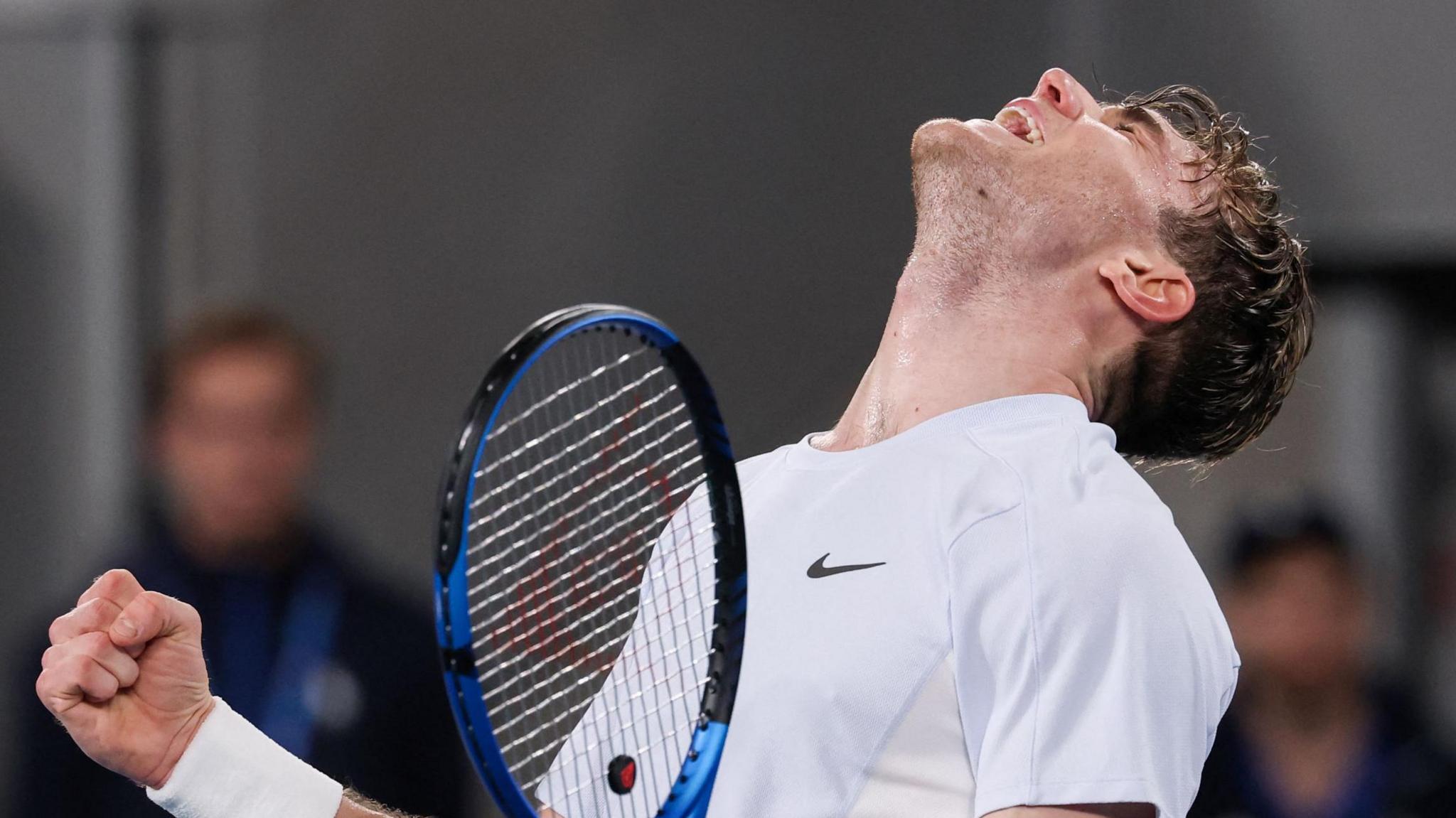 Jack Draper looks to the sky and roars after beating Aleksandar Vukic at the Australian Open