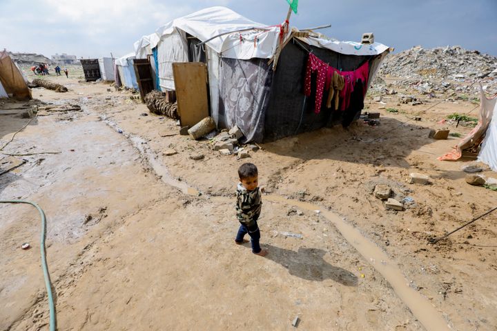 A child stands in a muddy area surrounded by tents in Gaza, on Feb. 11, 2025. Hamas has accused Israel of violating the truce by refusing to allow enough tents and temporary housing to enter Gaza, as displaced families continue to battle difficult weather without the shelters promised to them.