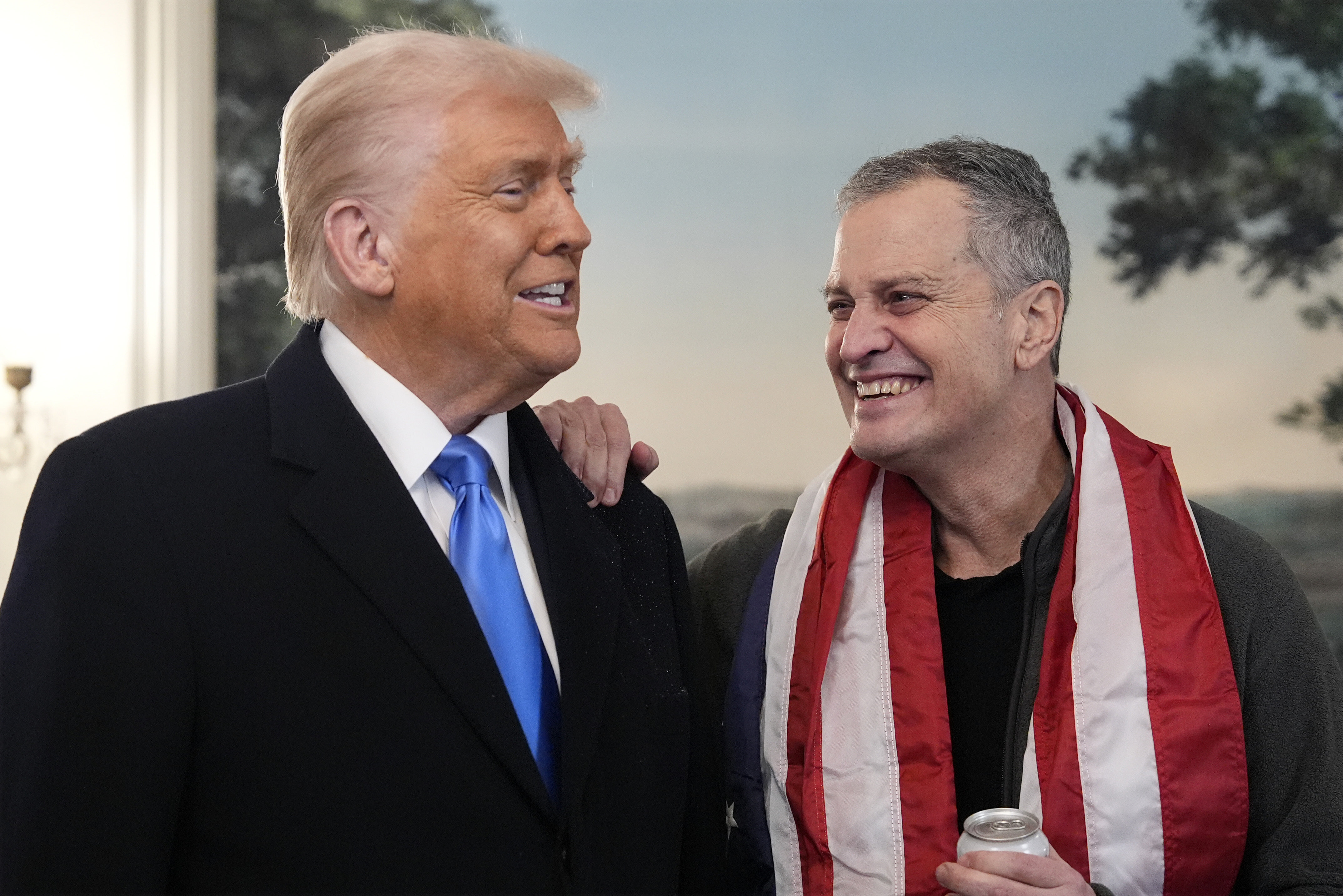 President Donald Trump, accompanied by Marc Fogel, speaks in the Diplomatic Reception Room at the White House, on Feb. 11 in Washington.