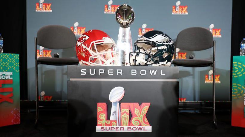 A Kansas City Chiefs helmet, the Vince Lombardi Trophy and a Philadelphia Eagles helmet 