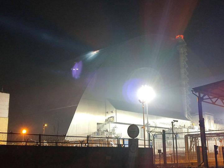 In this photo provided by the Ukrainian Emergency Service, a searchlight illuminates a hole in the roof of a damaged sarcophagus, that covers the destroyed 4th reactor of Chernobyl nuclear power plant, following a Russian drone attack in Chernobyl, Ukraine, on Feb. 14, 2025.