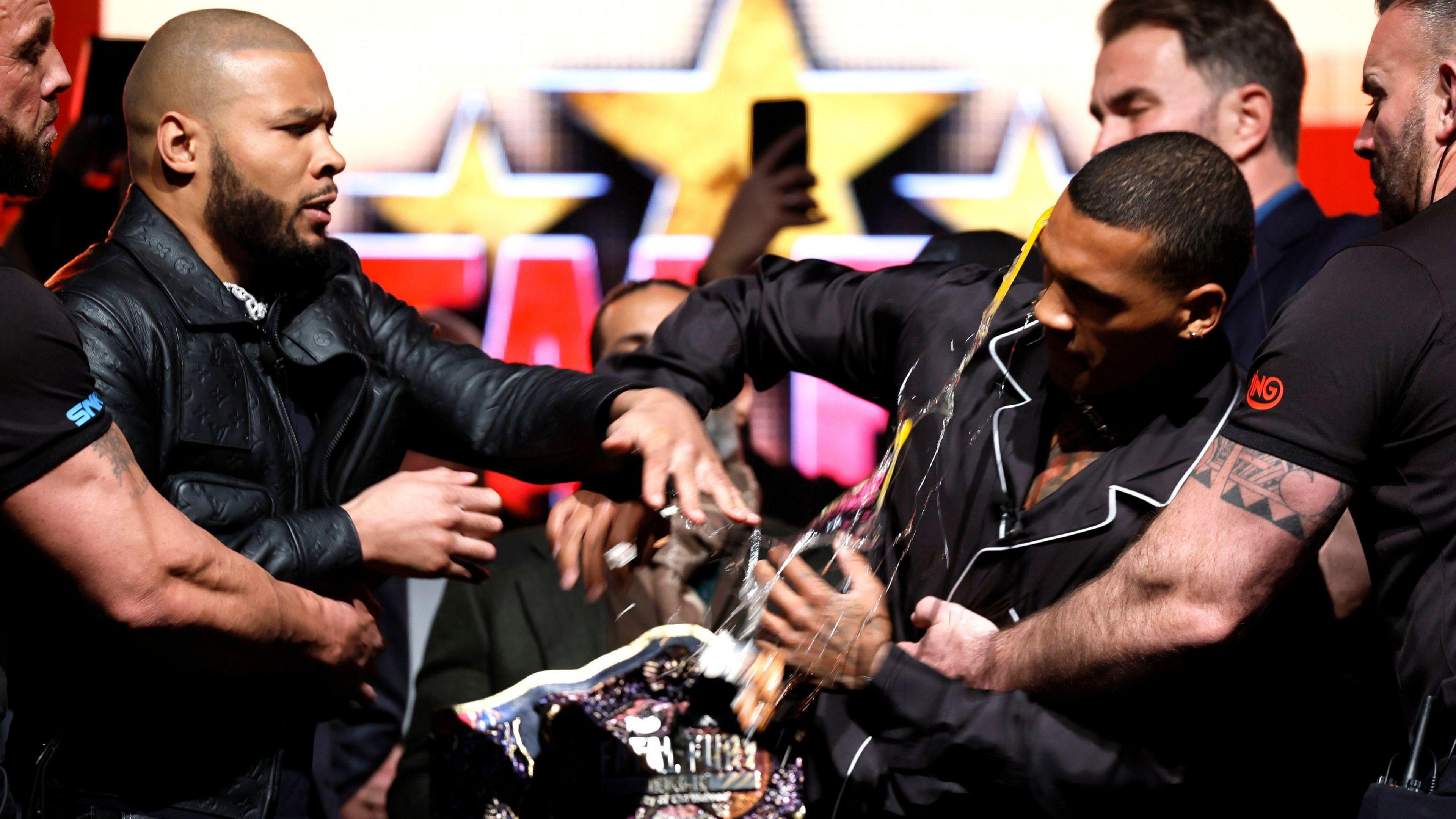 Chris Eubank Jr strikes Conor Benn with an egg during a media conference at Manchester Central