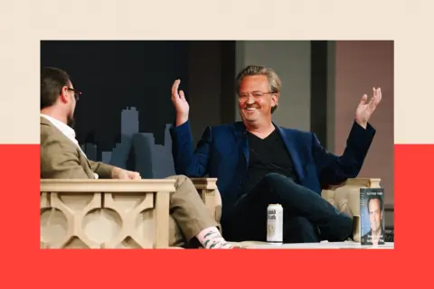 Getty Images Matthew Perry with his arms up in the air