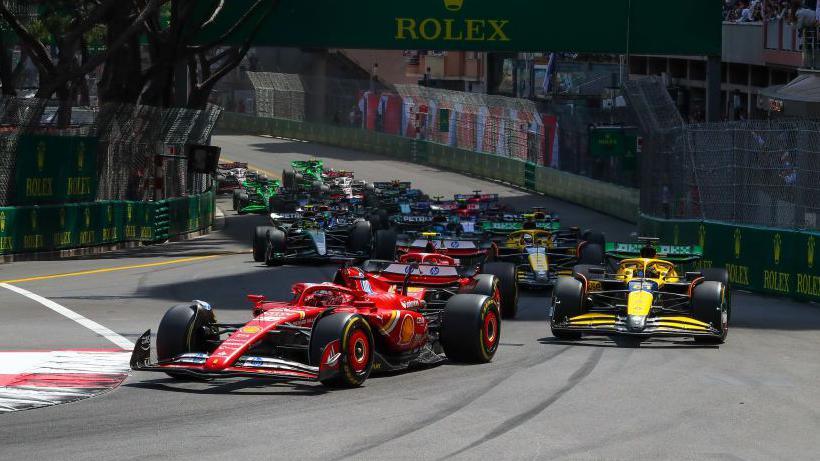 Charles Leclerc of Ferrari leads the field at the first corner of the 2024 Monaco Grand Prix