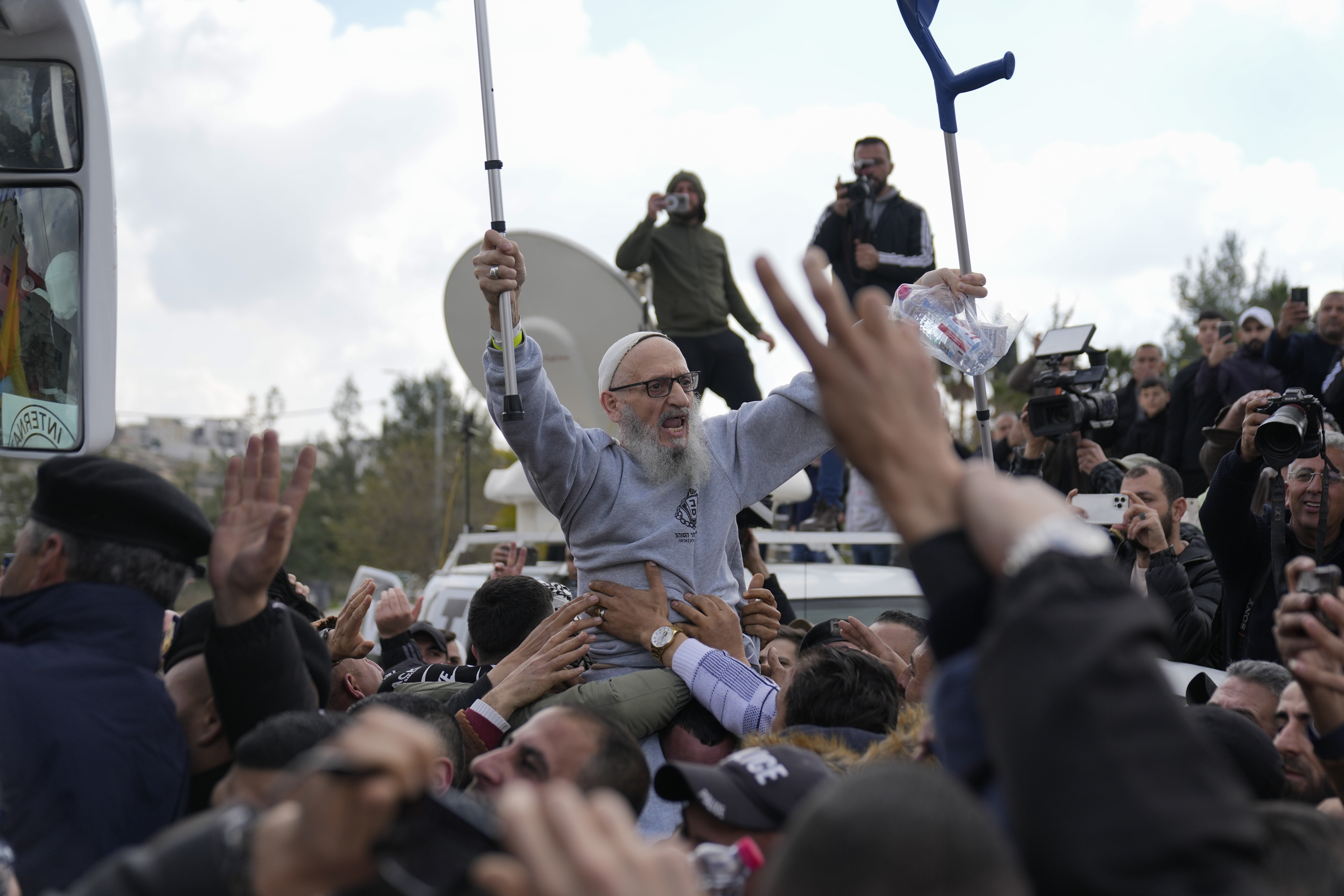 Palestinian prisoners are greeted as they exit a Red Cross bus after being released from Israeli prison following a ceasefire agreement between Israel and Hamas, in the West Bank city of Ramallah, Saturday Feb. 1, 2025. (AP Photo/Nasser Nasser)