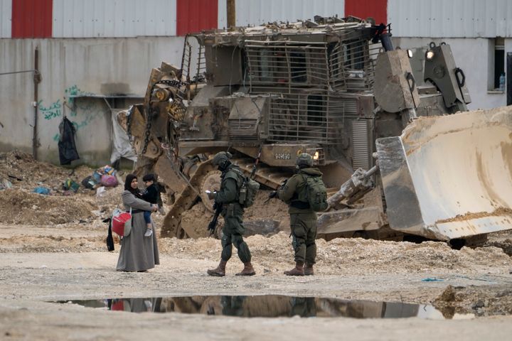 Israeli soldiers check the IDs of Palestinians in the West Bank refugee camp of Nur Shams, Tulkarem, as the military continues its operation in the area on Tuesday, Feb. 11, 2025.