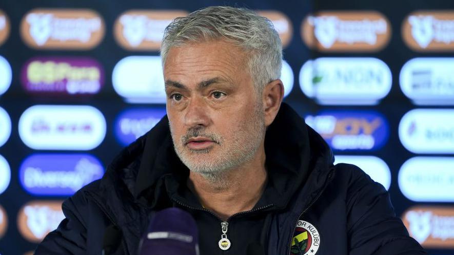 Jose Mourinho wearing a coat with a Fenerbahce badge