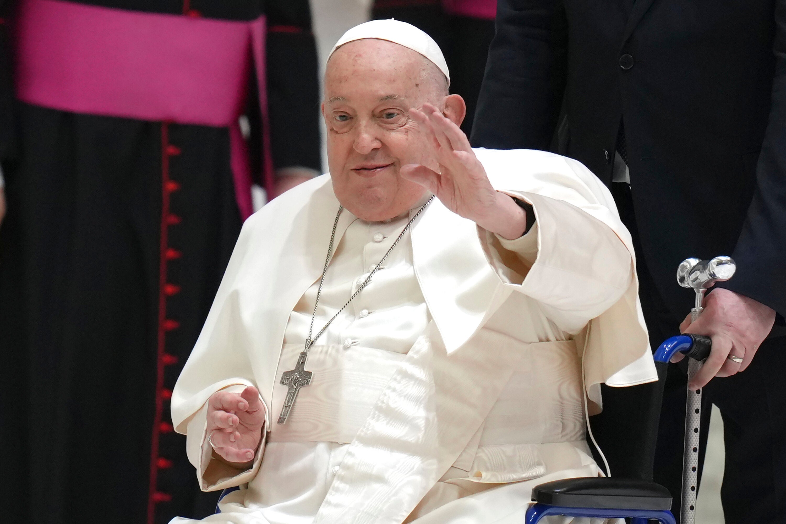 Pope Francis waves as he arrives for his weekly general audience in the Paul VI Hall, at the Vatican, Wednesday, Feb. 12, 2025. (AP Photo/Alessandra Tarantino)