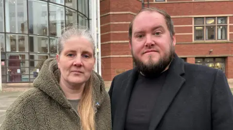 BBC An image of Sarah and Gary Andrews standing outside Nottingham Magistrates' Court 