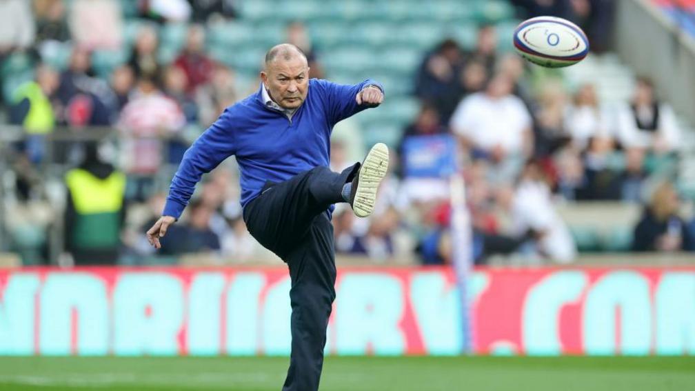 Eddie Jones kicks a rugby ball