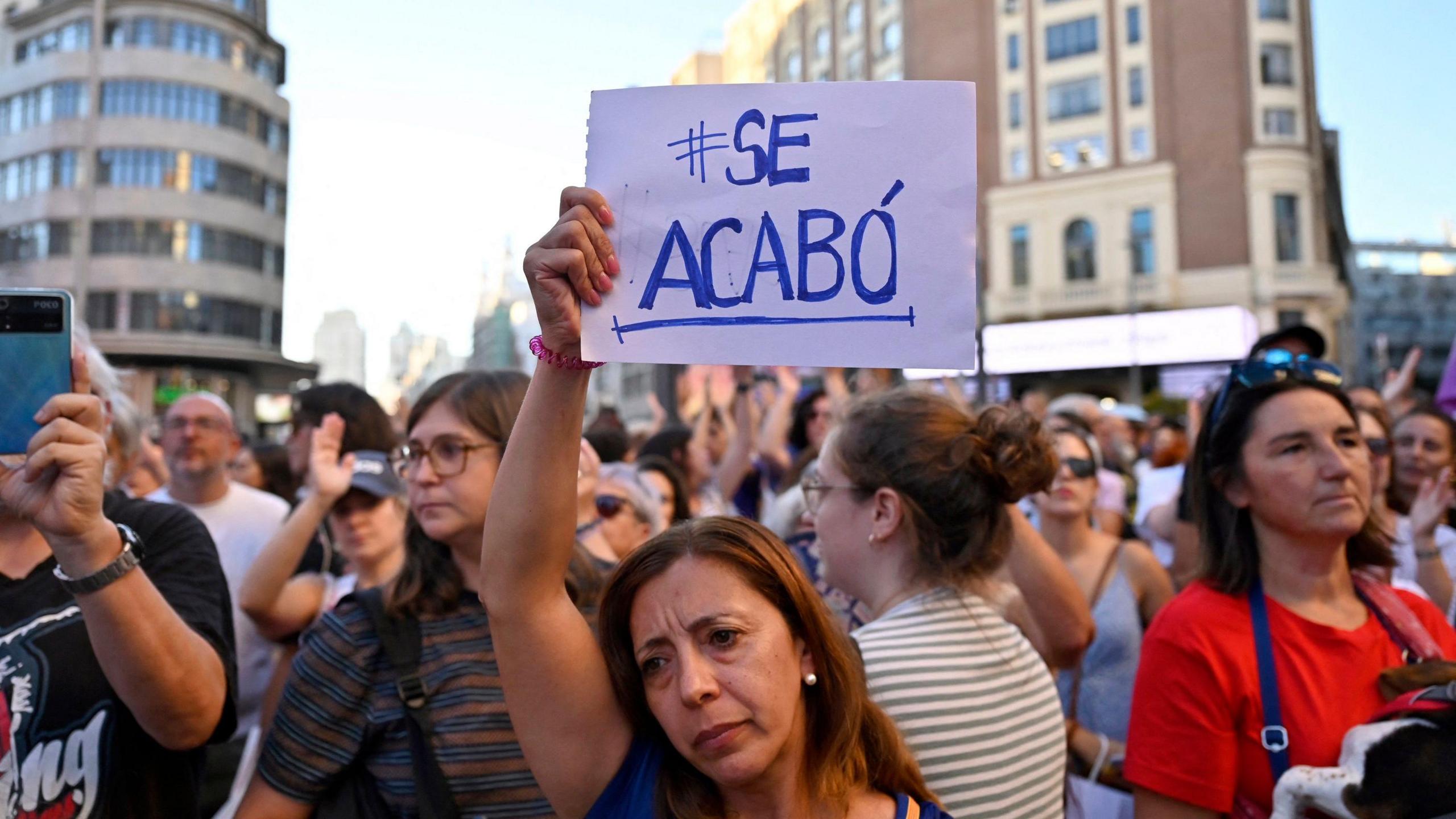 Protesters in Spain hold up signs saying 'Se Acabo' meaning 'it's over'