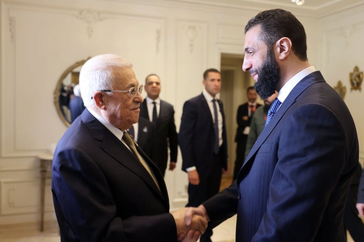 Palestinian President Mahmoud Abbas (L) greets Syrian President Ahmed al-Sharaa (R) amid the Arab League summit in Cairo, on March 4, 2025.