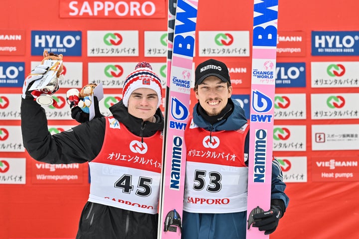 Norway's Marius Lindvik (L) poses with Norway's Johann Andre Forfang (R) at the end of the second day of the men's FIS Ski Jumping World Cup competition in Sapporo on February 16, 2025. (Photo by Richard A. Brooks / AFP) (Photo by RICHARD A. BROOKS/AFP via Getty Images)