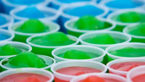 Getty Images Slushy ice drinks coloured blue, green and red all lined up in white plastic cups