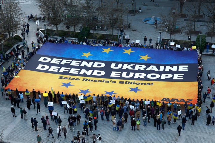 Activists unfurl a large banner in support of Ukraine outside the European Council building ahead of an EU summit in Brussels, Belgium, on March 5, 2025.