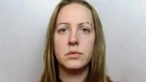 Cheshire Police A custody photograph of Lucy Letby who has long blonde hair and and is wearing a red top.