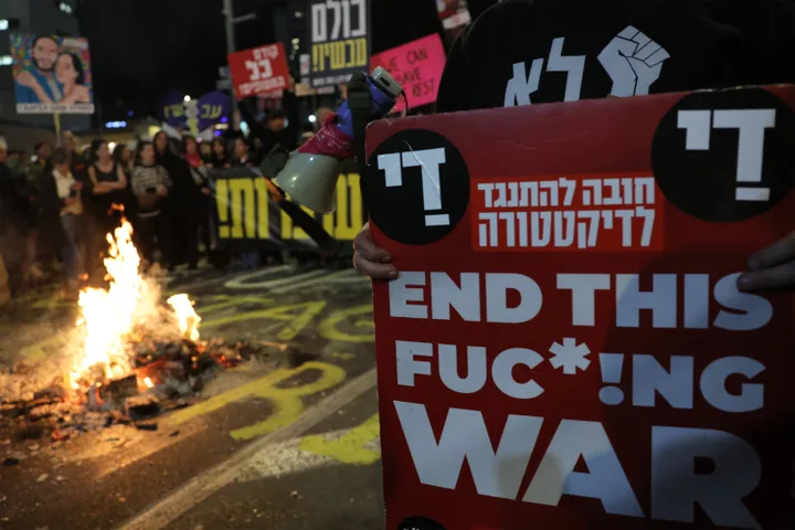 Demonstrators gather by a bonfire outside the Israeli Defense Ministry headquarters in Tel Aviv on March 1, 2025, calling for the remaining hostages taken by Hamas to be released.