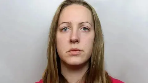 Cheshire Police Custody image of Lucy Letby, who has long blonde hair and is wearing a red top.