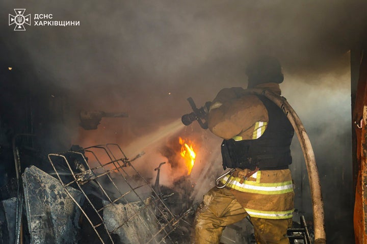 In this photo provided by the Ukrainian Emergency Service, a firefighter works to extinguish the fire following a Russian rocket attack in Kharkiv, Ukraine, on March 7, 2025.