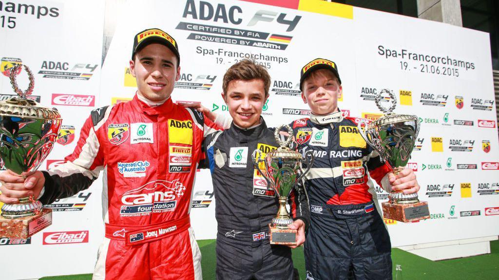 Lando Norris on the podium after winning a Formula 4 race at Spa in Belgium in 2015