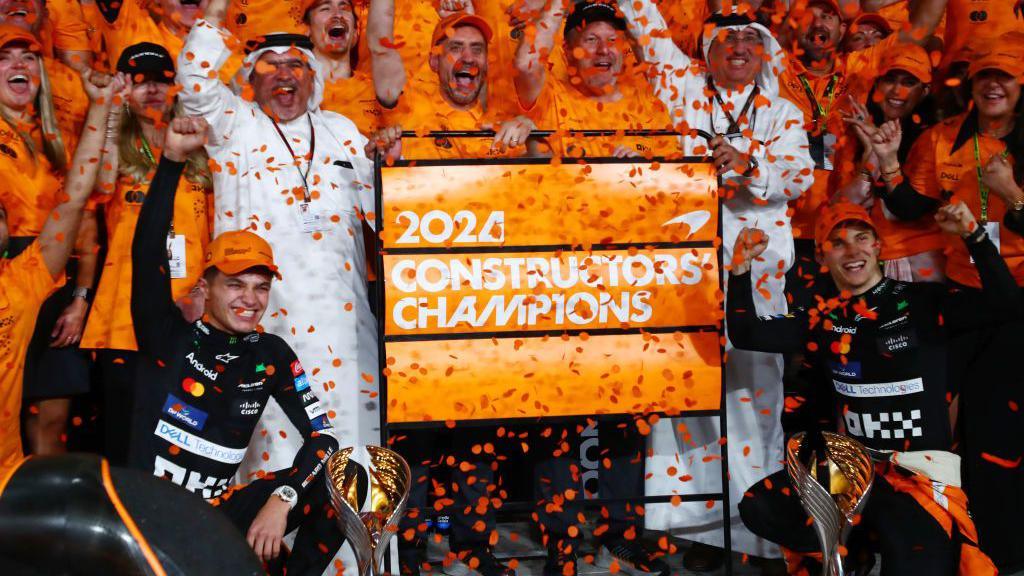 McLaren drivers Lando Norris and Oscar Piastri celebrate winning the constructors' championship with their team.