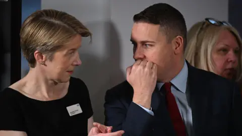 Getty Images Pritchard and Wes Streeting speaking as they listen to a speech by Prime Minister Keir Starmer on reducing NHS wait times